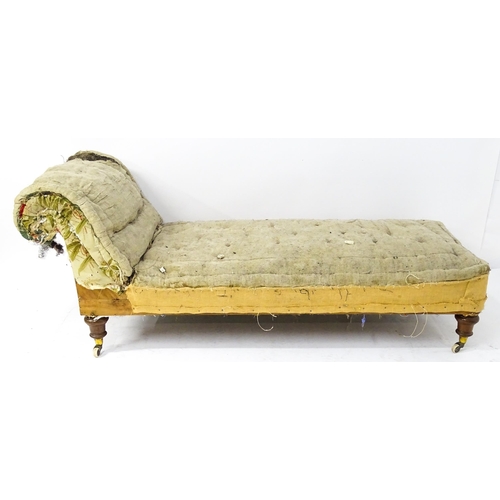 261 - A Victorian chaise longue / day bed, the mahogany frame with scrolling end and raised on four turned... 