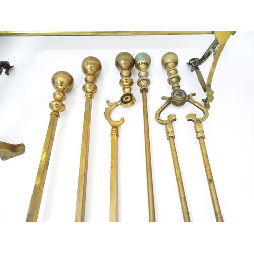 663 - A quantity of 20thC brass fire tools, to include pokers, shovels, stands and tongs etc, together wit... 