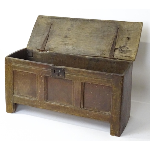 1 - An 18thC oak coffer / sword chest with a hinged lid above a panelled front raised on stile feet. 41