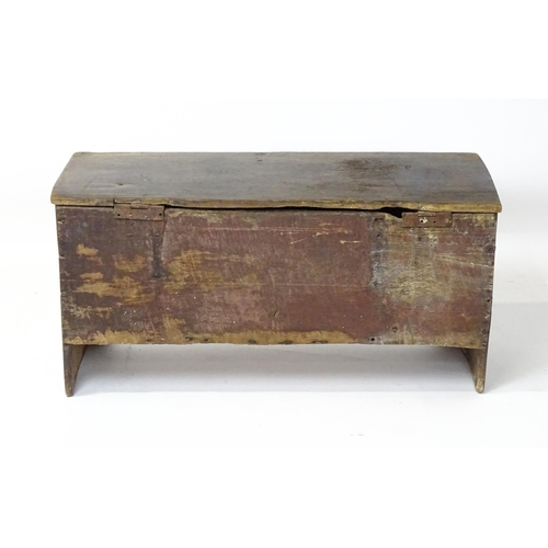 1 - An 18thC oak coffer / sword chest with a hinged lid above a panelled front raised on stile feet. 41