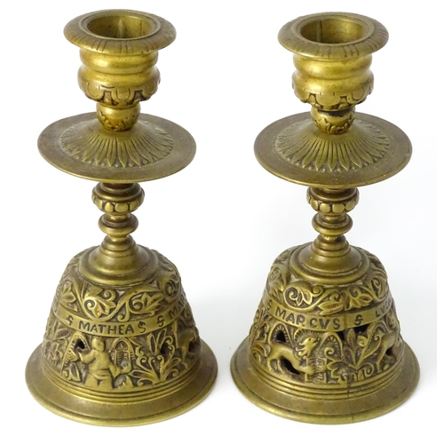 634 - A pair of 20thC cast brass candlesticks with openwork decoration and apostle detail to base. Approx.... 