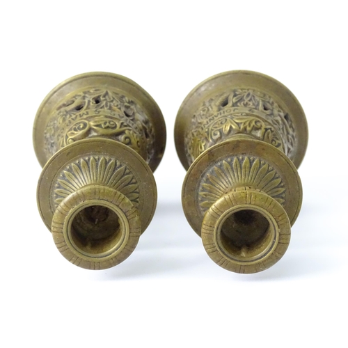 634 - A pair of 20thC cast brass candlesticks with openwork decoration and apostle detail to base. Approx.... 