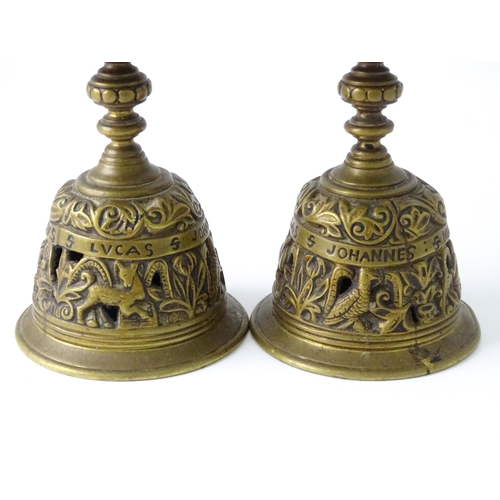 634 - A pair of 20thC cast brass candlesticks with openwork decoration and apostle detail to base. Approx.... 