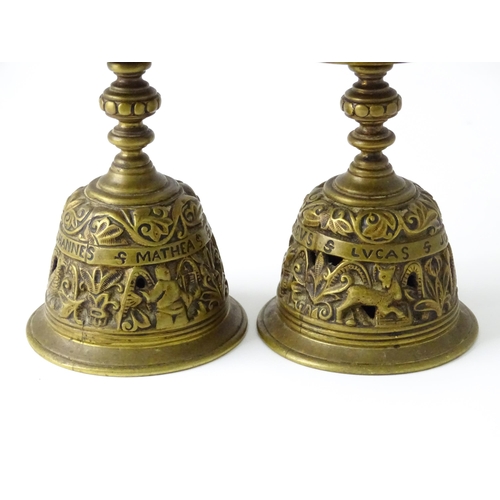 634 - A pair of 20thC cast brass candlesticks with openwork decoration and apostle detail to base. Approx.... 