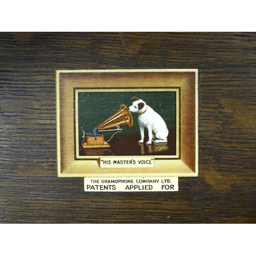 227 - An early to mid 20thC 'His Master's Voice /The Gramophone Company' gramophone in oak case, approx 18... 