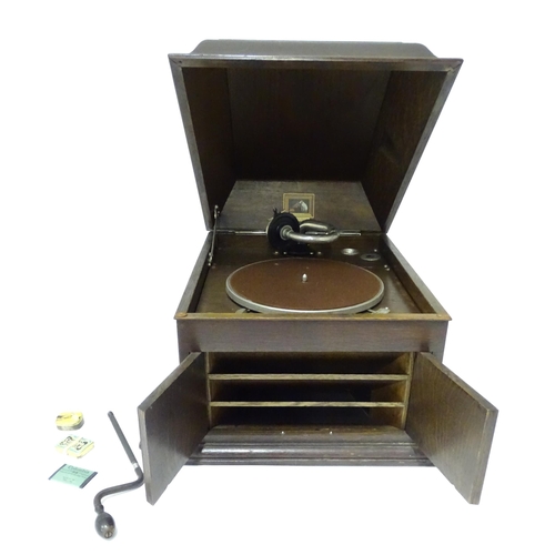 227 - An early to mid 20thC 'His Master's Voice /The Gramophone Company' gramophone in oak case, approx 18... 