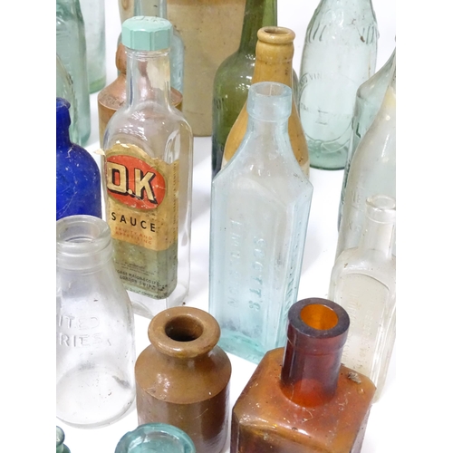 244 - A quantity of old bottles to include gingerbeers, codd, Princes Risborough milk bottle with original... 