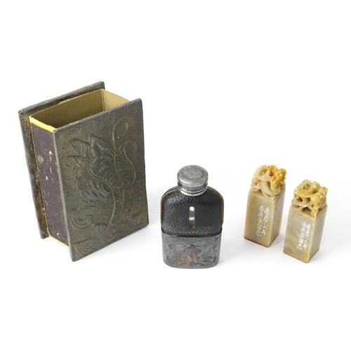 537 - Four assorted items, comprising an Art Nouveau pewter matchbox cover, a small hip flask and two Orie... 