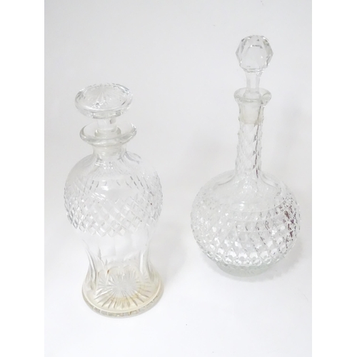 253 - A quantity of assorted cut glass and lead crystal decanters, to include a Bohemian red glass example... 