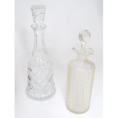 253 - A quantity of assorted cut glass and lead crystal decanters, to include a Bohemian red glass example... 