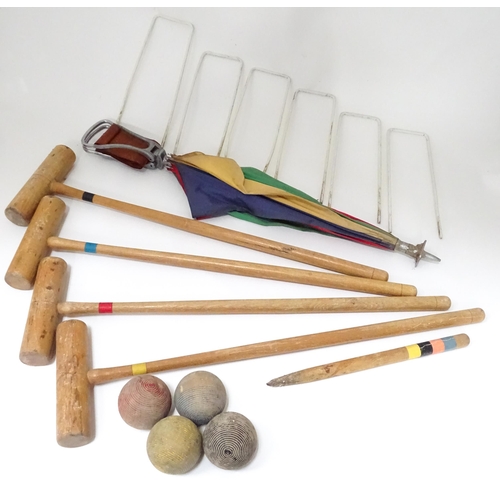 254 - A mid 20thC part croquet set comprising four mallets, four jacks, six wickets and a centre stake, to... 