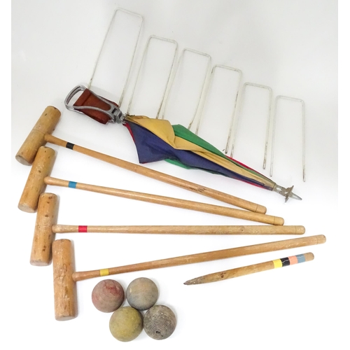 254 - A mid 20thC part croquet set comprising four mallets, four jacks, six wickets and a centre stake, to... 