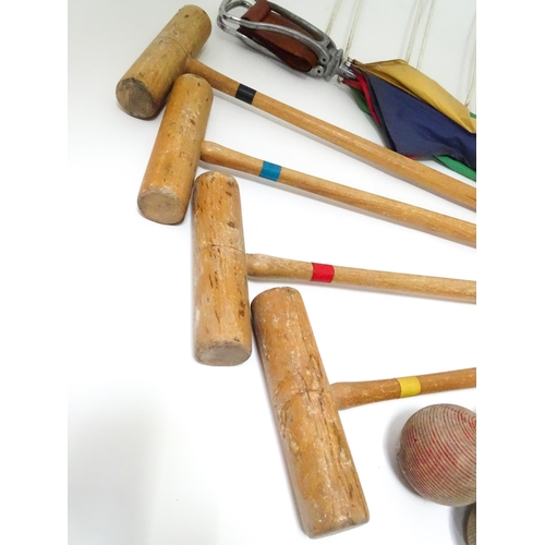 254 - A mid 20thC part croquet set comprising four mallets, four jacks, six wickets and a centre stake, to... 