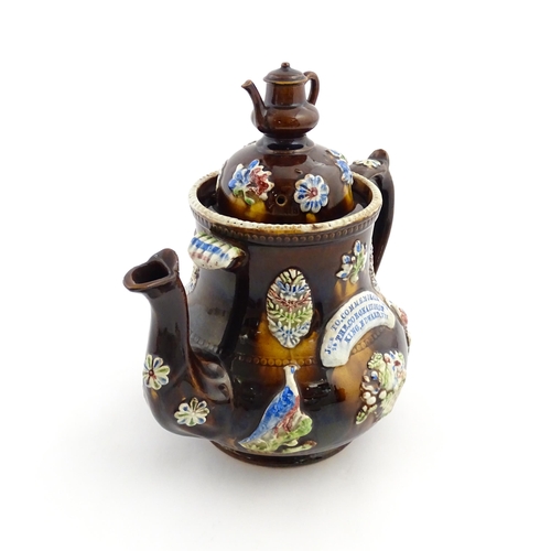 239 - A Measham bargeware commemorative teapot with teapot finial to lid, decorated with birds, flowers, f... 