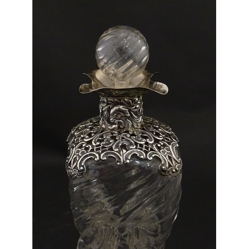 258 - A Victorian glass glug glug / pinch decanter with a pierced silver mount hallmarked London 1898, mak... 