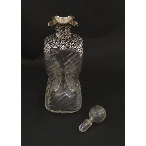 258 - A Victorian glass glug glug / pinch decanter with a pierced silver mount hallmarked London 1898, mak... 