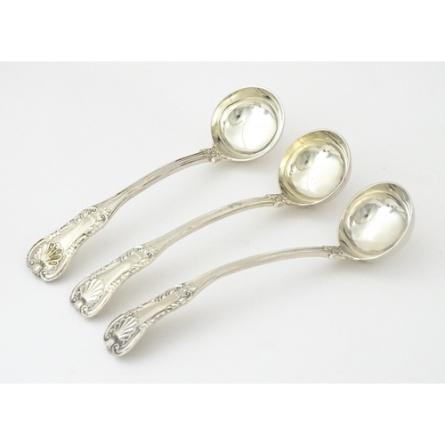 587 - Three 19thC Scottish silver King's pattern cream ladles hallmarked Glasgow 1830, maker WM AM. Approx... 