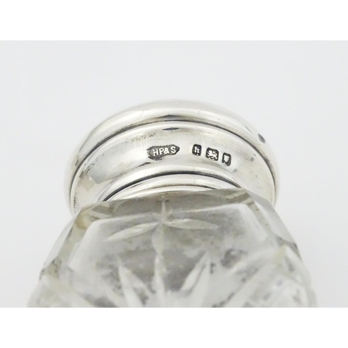 595 - A cut glass salts bottle with silver top hallmarked London 1923, maker Henry Perkins & Sons, a dress... 