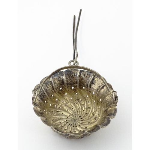 599 - A Chinese Export silver strainer of basket form with engraved decoration and spout hanger