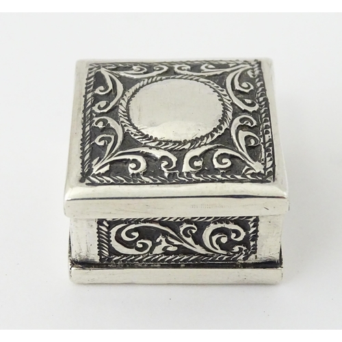 605 - A white metal pill box of squared form with scroll and elephant decoration. Indistinctly marked, pos... 