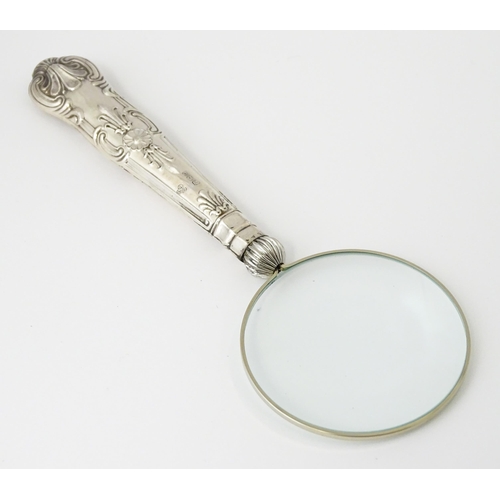 606 - A silver handled magnifying glass. Approx. 6 1/4