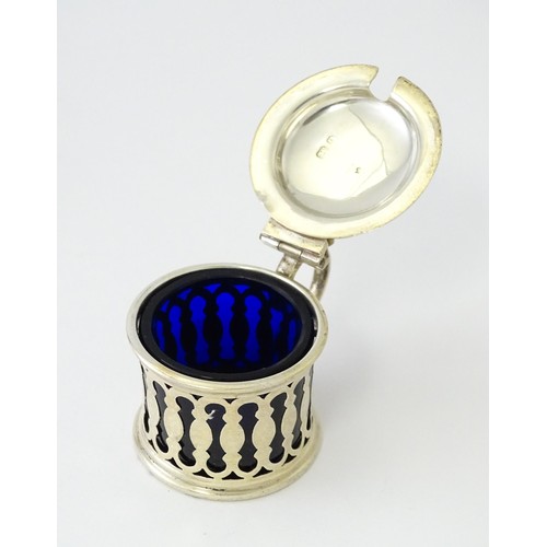 611 - A silver pepper with blue pierced decoration and glass liner, hallmarked Birmingham 1913, maker Henr... 