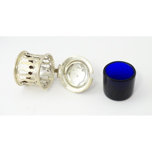 611 - A silver pepper with blue pierced decoration and glass liner, hallmarked Birmingham 1913, maker Henr... 