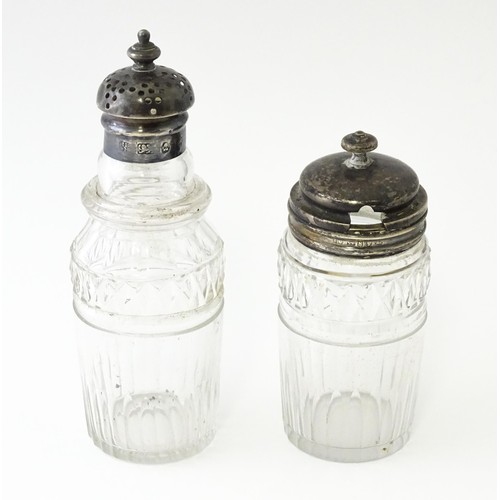 612 - Two glass cruet bottles with silver lids, one hallmarked Geo IV Sheffield 1827, maker Howard Battie ... 