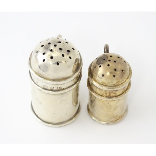 615 - Two small novelty silver pepperettes of flour shaker form, one Victorian example hallmarked Birmingh... 