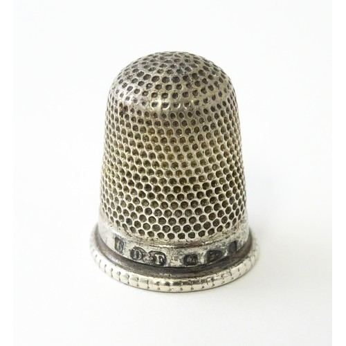 616 - A Victorian silver thimble hallmarked Chester 1897, maker Deakin & Francis. Together with a DORCAS C... 