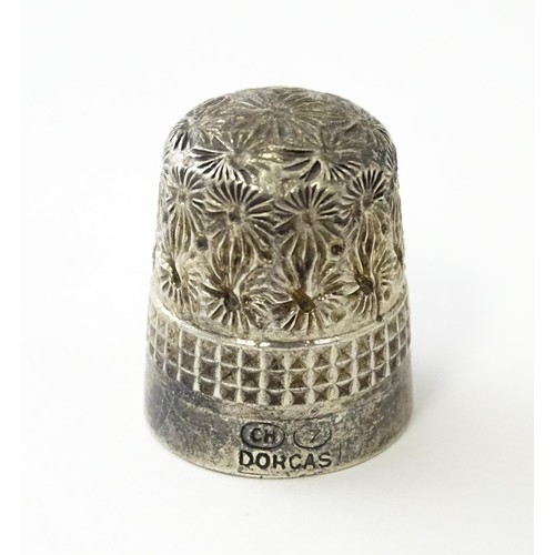 616 - A Victorian silver thimble hallmarked Chester 1897, maker Deakin & Francis. Together with a DORCAS C... 