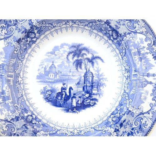 90 - A 19thC blue and white meat plate / platter, together with three matching soup bowls decorated with ... 