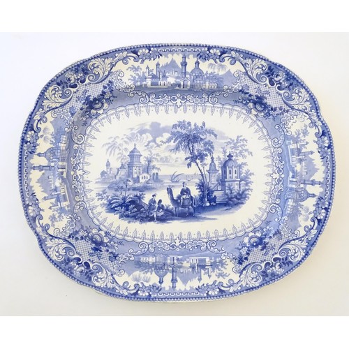 90 - A 19thC blue and white meat plate / platter, together with three matching soup bowls decorated with ... 