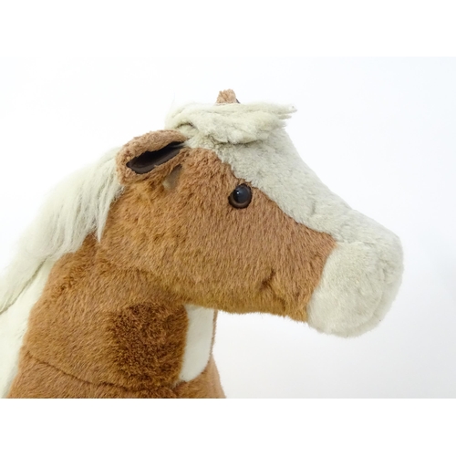 1190 - Toy: A Mulholland & Bailie brown and white plush rocking horse on a wooden trestle base. Bears label... 