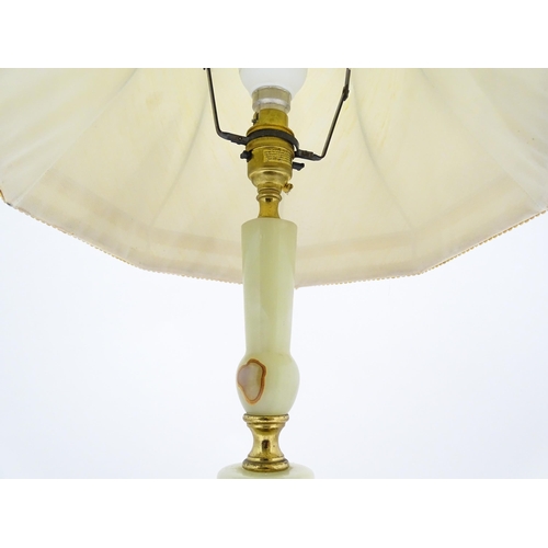 1672 - A 20thC table lamp with onyx style turned base. Approx. 18