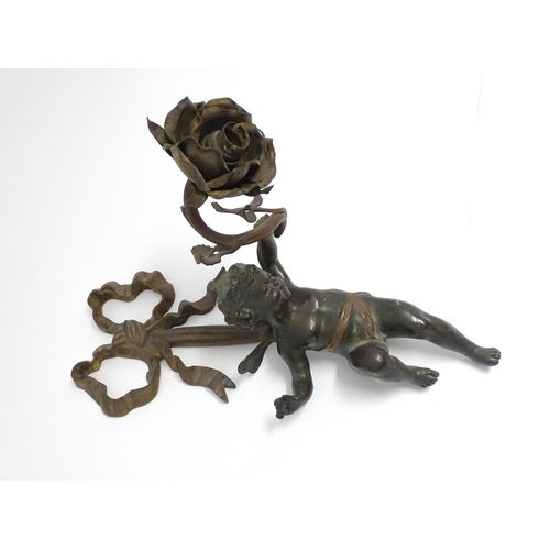 1699 - A cast bronze wall light sconce modelled as a cherub holding aloft a scrolling flower. Approx. 12