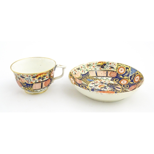 100 - A Derby tea cup and saucer decorated in the Imari palette with flowers, foliage and roundel detail. ... 