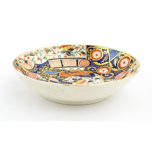 100 - A Derby tea cup and saucer decorated in the Imari palette with flowers, foliage and roundel detail. ... 