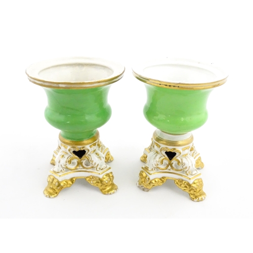 101 - A pair of small Bloor Derby vases of urn form, each with green glazed body and pierced base with gil... 