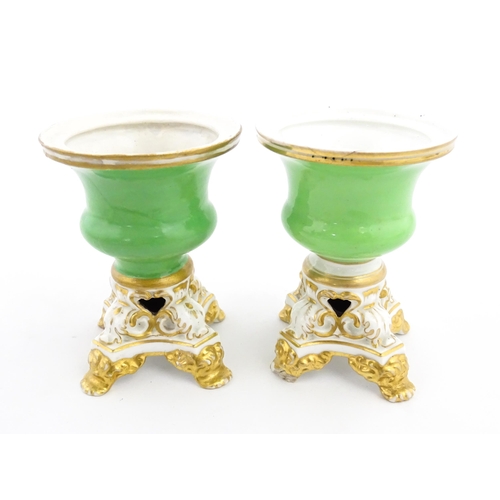 101 - A pair of small Bloor Derby vases of urn form, each with green glazed body and pierced base with gil... 