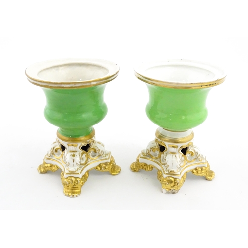 101 - A pair of small Bloor Derby vases of urn form, each with green glazed body and pierced base with gil... 