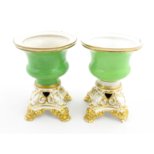 101 - A pair of small Bloor Derby vases of urn form, each with green glazed body and pierced base with gil... 