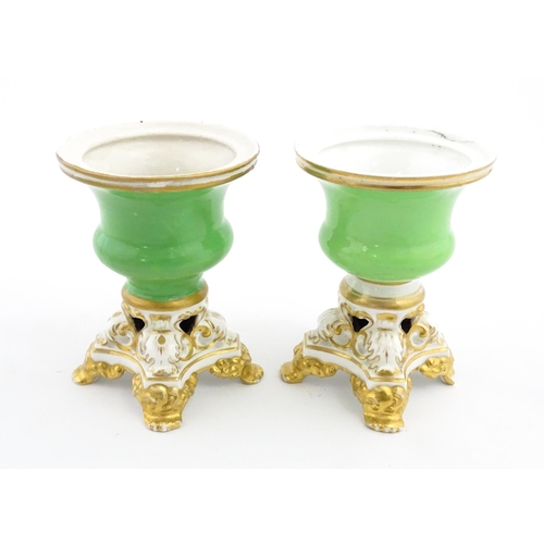 101 - A pair of small Bloor Derby vases of urn form, each with green glazed body and pierced base with gil... 