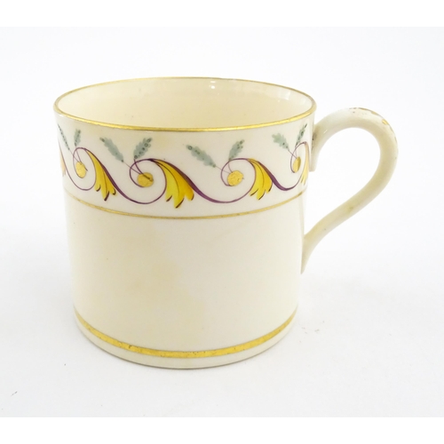 102 - An English 19thC coffee cup with yellow, green and gilt banded detail. Approx. 2