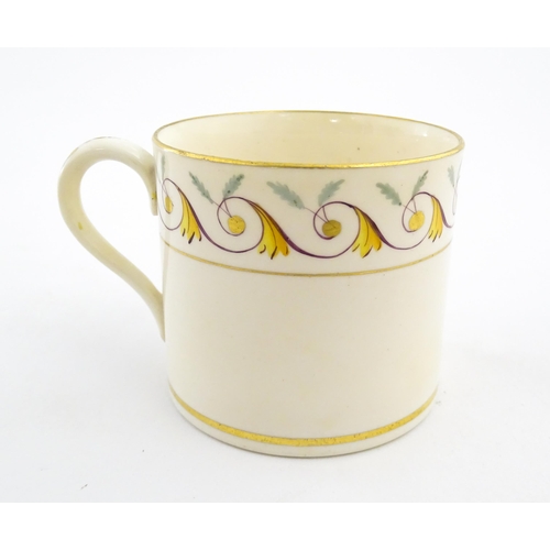 102 - An English 19thC coffee cup with yellow, green and gilt banded detail. Approx. 2