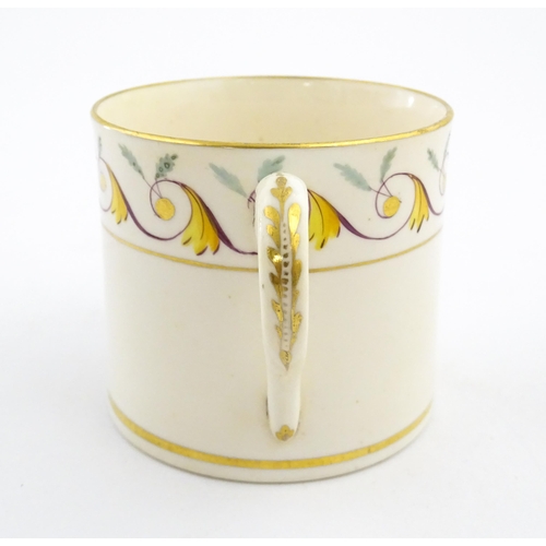 102 - An English 19thC coffee cup with yellow, green and gilt banded detail. Approx. 2