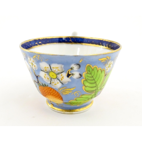 106 - A 19thC tea cup and saucer decorated with strawberry and flower detail. Cup approx. 2 1/4