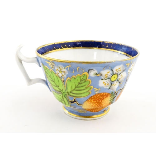 106 - A 19thC tea cup and saucer decorated with strawberry and flower detail. Cup approx. 2 1/4