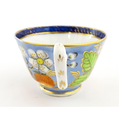 106 - A 19thC tea cup and saucer decorated with strawberry and flower detail. Cup approx. 2 1/4