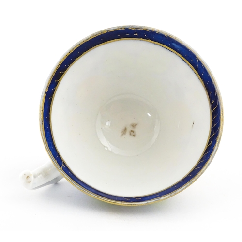 106 - A 19thC tea cup and saucer decorated with strawberry and flower detail. Cup approx. 2 1/4